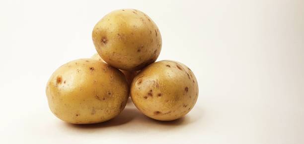 istock Bunch of potatoes isolated on white background 1283003074