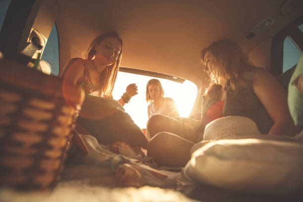 istock Three best friends fun in the car trunk while camping 1283004253