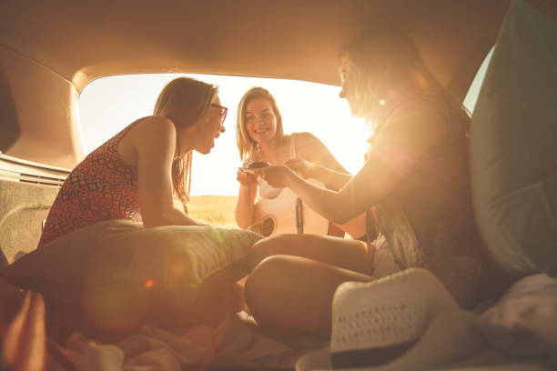 istock Female friends fun in the car trunk while camping 1283004255