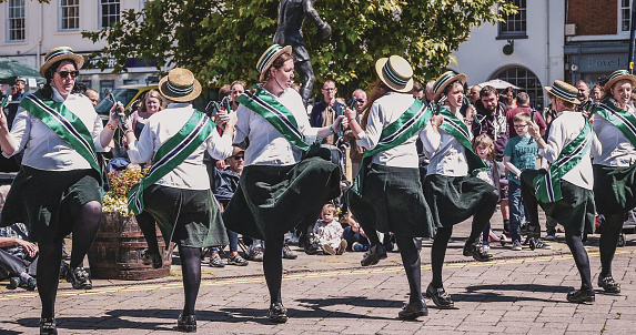 October 20th.2020. This is a group of morris dancers performing at the warwick folk festival warwickshire Englnad UK. It is a sunny afternoon and there are lots of people watching the dancers who are performing traditional historic dances.