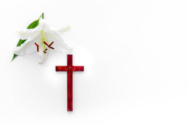 istock Lily funeral flower with cross. Condolence card with copy space 1283008803
