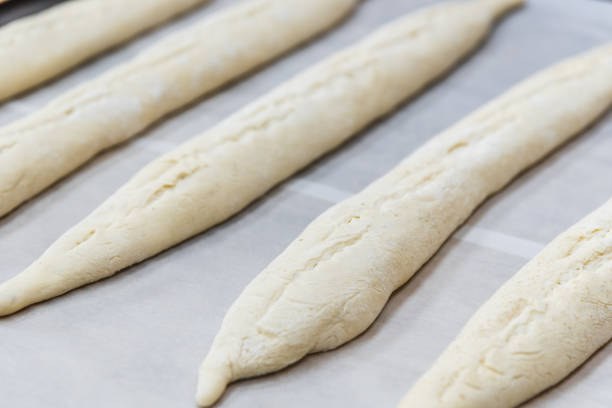 istock Making craft bread at the bakery. Close-up of a baker and bread, blurred background 1283009308