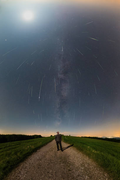 istock Milky way with moon and perseid meteor shower 1283010331