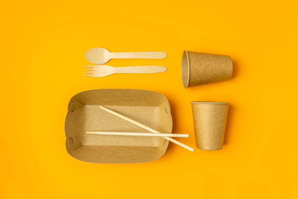 istock No more plastic. Bamboo cutlery and paper dishes on yellow background, flat lay. Zero waste concept. 1283010648