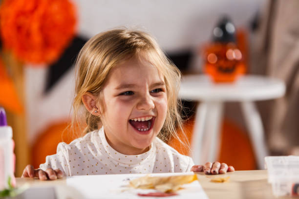 istock Little girl laughing while doing arts and crafts 1283011037
