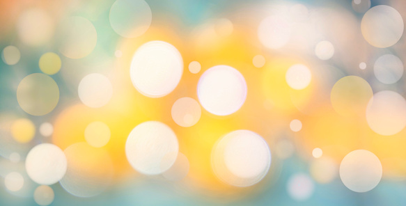 White and yellow defocused lights on blurred blue background