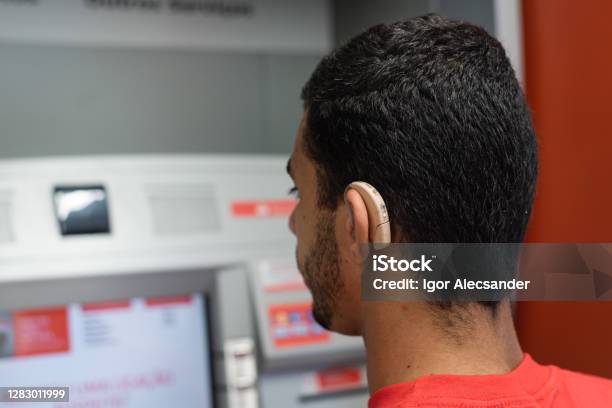 Deaf Young Man At Bank Atm Stock Photo - Download Image Now - Deafness, Accessibility for Persons with Disabilities, Bank - Financial Building