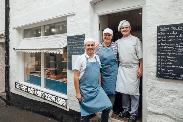 Our Family Bakery A family of bakers stood at the front door of their lovely little artisan bakery in Polperro, Cornwall artisanal food and drink photos stock pictures, royalty-free photos & images