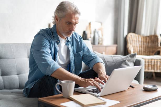 istock Middle-aged man working from home-office on laptop. 1283012290
