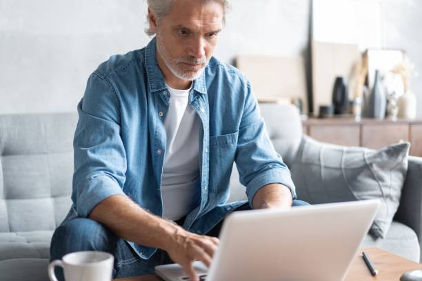 istock Middle-aged man working from home-office on laptop. 1283012310