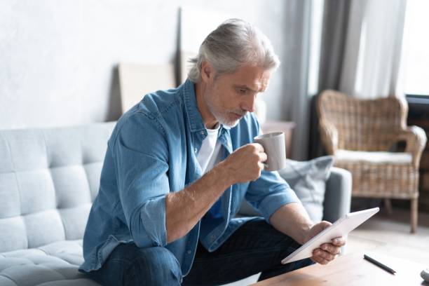istock Handsome businessman working on tablet from home. 1283012456