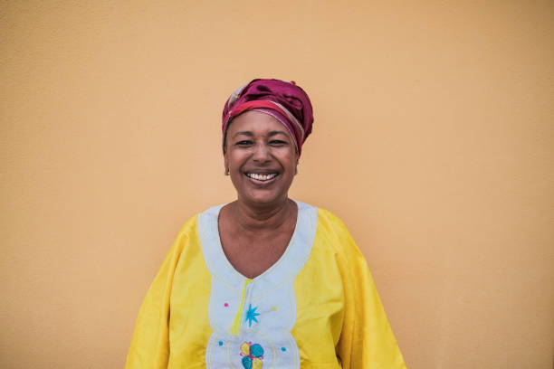 Portrait of happy african senior woman wearing traditional dress Portrait of happy african senior woman wearing traditional dress turban stock pictures, royalty-free photos & images