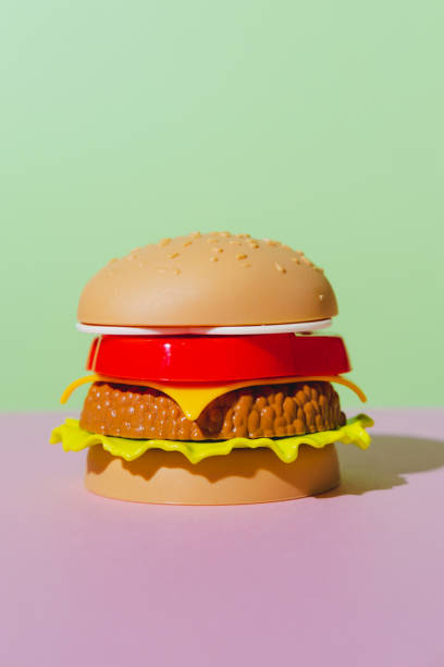 istock Appetizing burger on green and pink background. Creative concept. Plastic pop art style. Minimalism 1283015532
