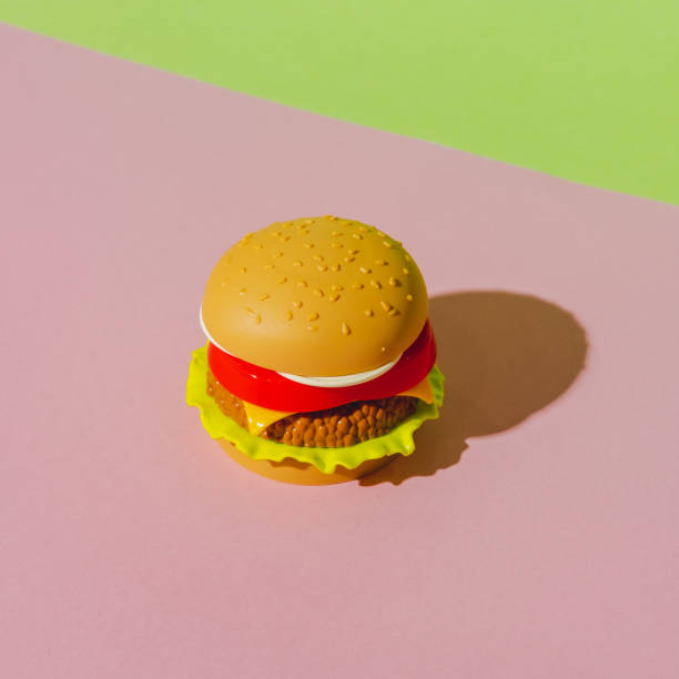 istock Appetizing burger with shadow on green and pink background. Creative concept. Plastic pop art isometric style. Minimalism 1283016059