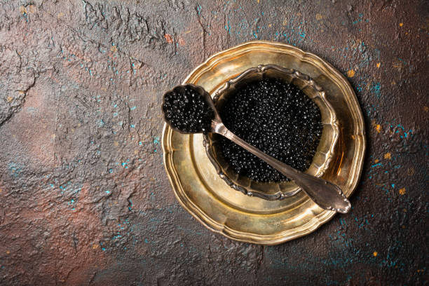 istock Bowl with appetizing black caviar and vintage silver spoon 1283017709