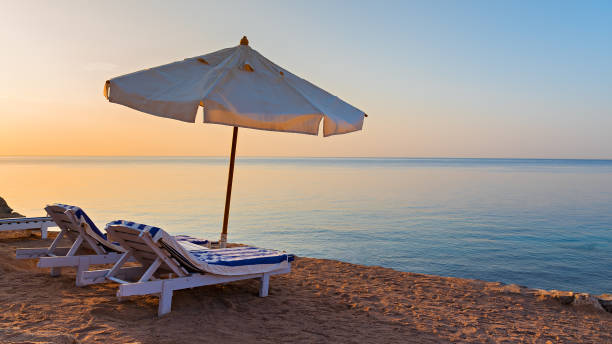 istock Beach with umbrella and sunbed in luxury hotel 1283018098