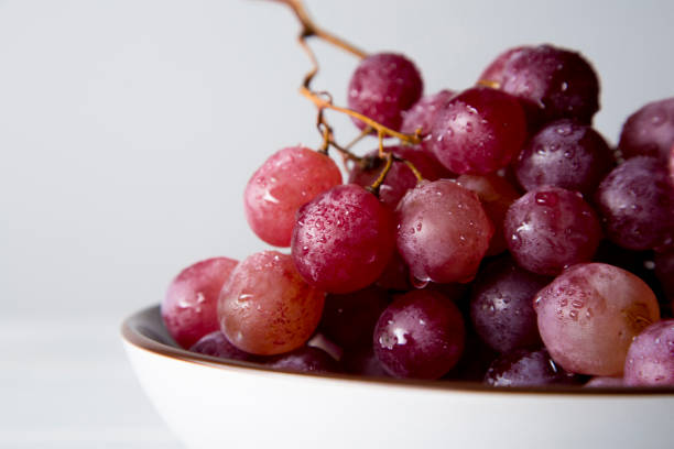 istock still life of red grapes on white wooden table 1283020430