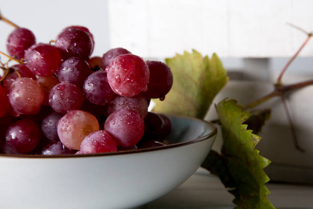 istock still life of red grapes on white wooden table 1283020431