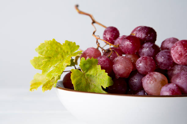 istock still life of red grapes on white wooden table 1283020443