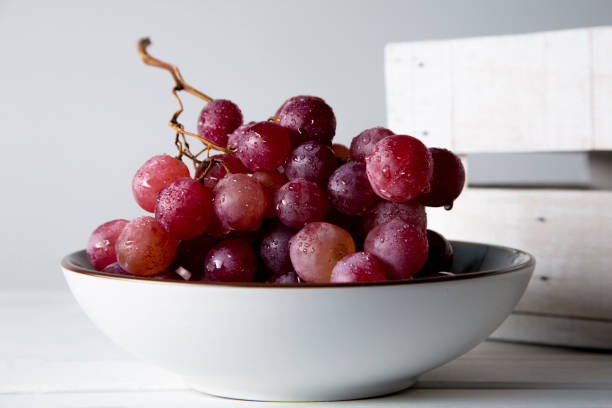 istock still life of red grapes on white wooden table 1283020452