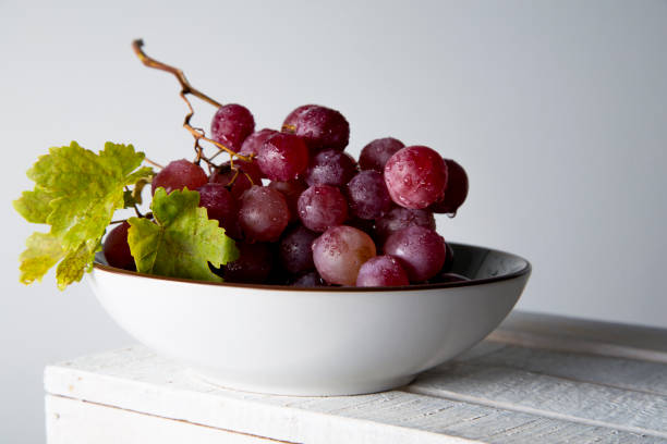 istock still life of red grapes on white wooden table 1283020465