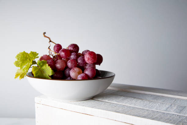 istock still life of red grapes on white wooden table 1283020468