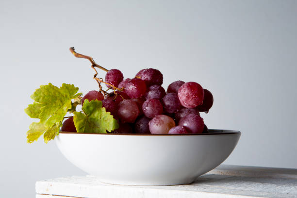 istock still life of red grapes on white wooden table 1283020470