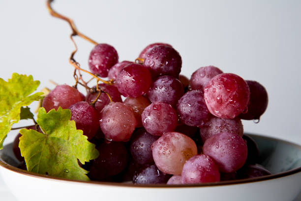 istock still life of red grapes on white wooden table 1283020472