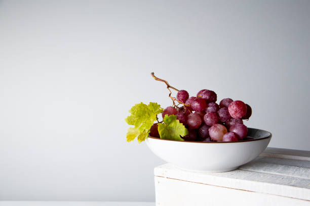 istock still life of red grapes on white wooden table 1283020485