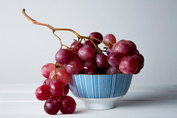 istock still life of red grapes on white wooden table 1283020486