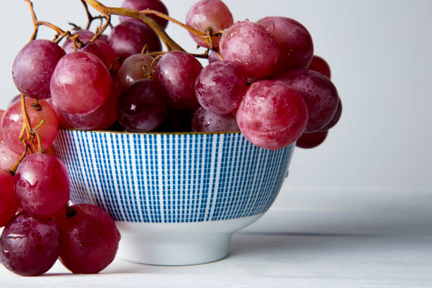 istock still life of red grapes on white wooden table 1283020497