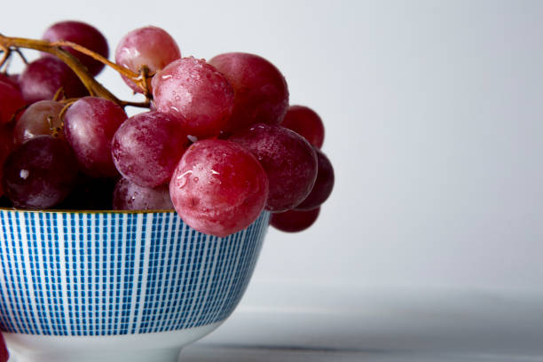 istock still life of red grapes on white wooden table 1283020498