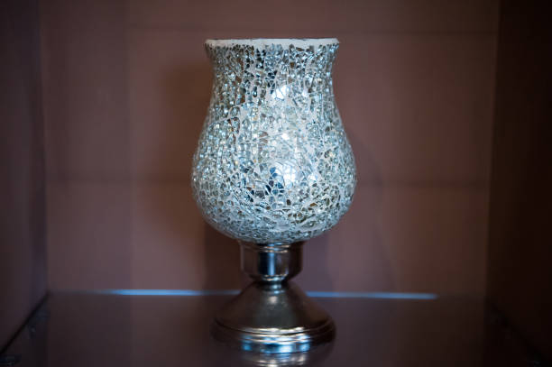 istock Vase of broken mirror pieces on metal standing 1283020701