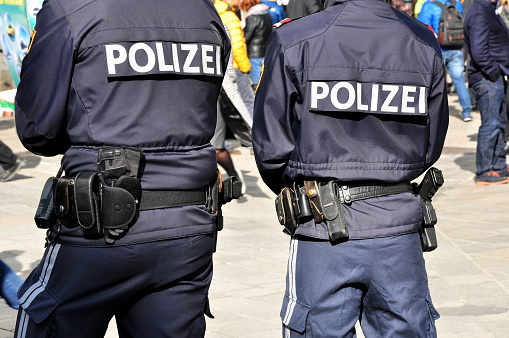 Backview of two policemen on patrol in vienna city