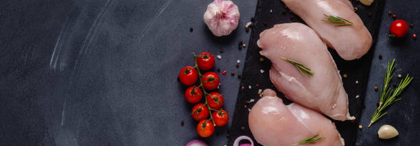 istock Raw chicken fillet with spices and herbs 1283021074