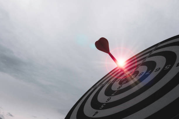 istock Dart arrow hit dartboard and goal with sunlight ,Setup objectives and target for business investment concept. 1283021154