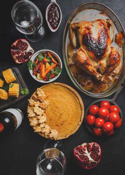 istock Thanksgiving party table with turkey, vegetables and pumpkin pie 1283021886