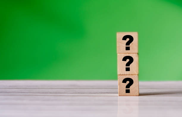 istock Three question mark sign on wooden block. Stack of question mark. quiz concept background 1283022209