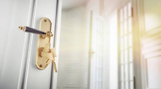 Key in the door lock in front of an empty art nouveau apartment