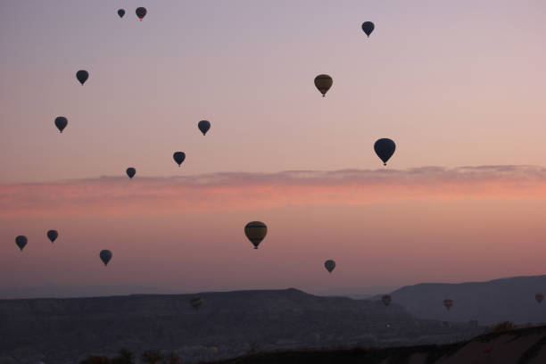 istock Red sunset sky with flying hot air balloons. 1283024130