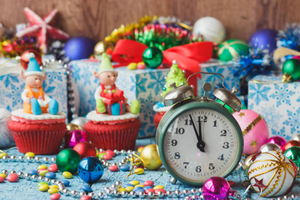 istock Christmas clock and cupcakes with colored decorations 1283024245