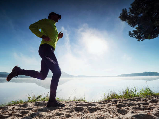 istock Morning condition workout on beach. Silhouette run 1283026406