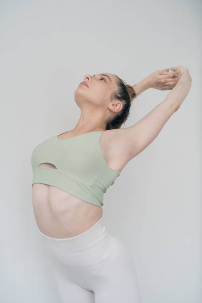 istock Athletic girl doing warm-up exercises for shoulders muscles 1283026594
