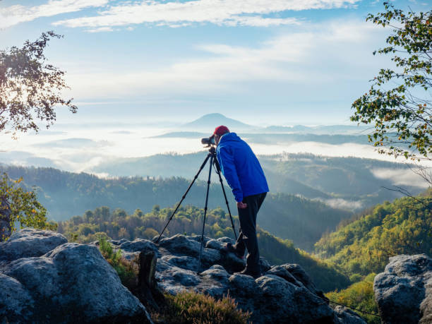 istock Photographer framing scene in viewfinder. Man use camera 1283026983