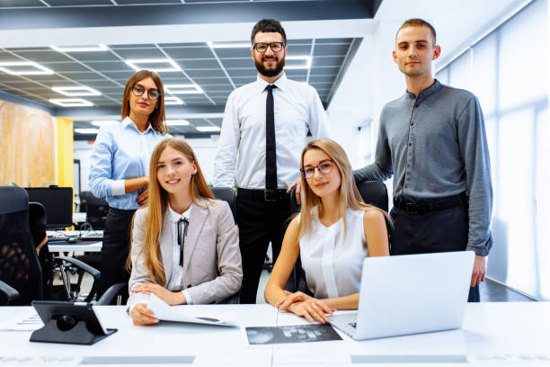 istock Successful business team standing together and smiling working in the office 1283027180