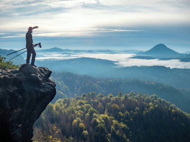 istock Photographer use mirror camera and tripod on peak 1283027736