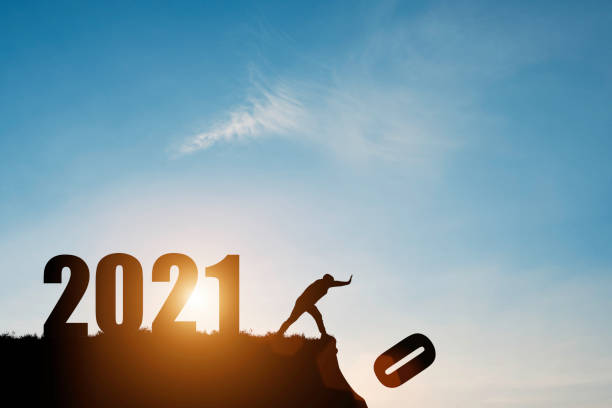 man push number zero down the cliff where has the number 2021 with blue sky and sunrise. it is symbol of starting and welcome happy new year 2021. - aspirations what vacations sport imagens e fotografias de stock