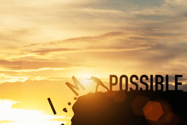 Businessman push impossible wording to possible wording on top of mountain with sunlight. Positive mindset concept. Businessman push impossible wording to possible wording on top of mountain with sunlight. Positive mindset concept. challenge stock pictures, royalty-free photos & images