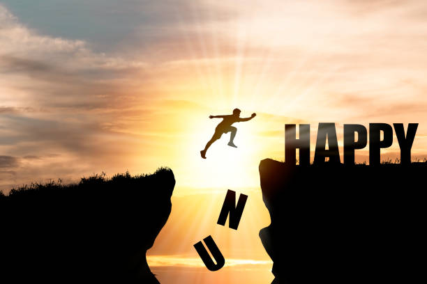 istock Human jumping over cliff and unhappy , happy wording with cloudscape sunrise. 1283028574