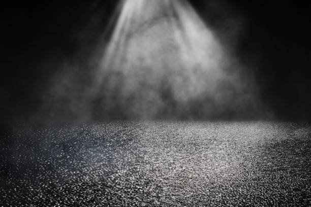 istock Empty wet asphalt road with lighting effect and smoke or mist in background. 1283030200